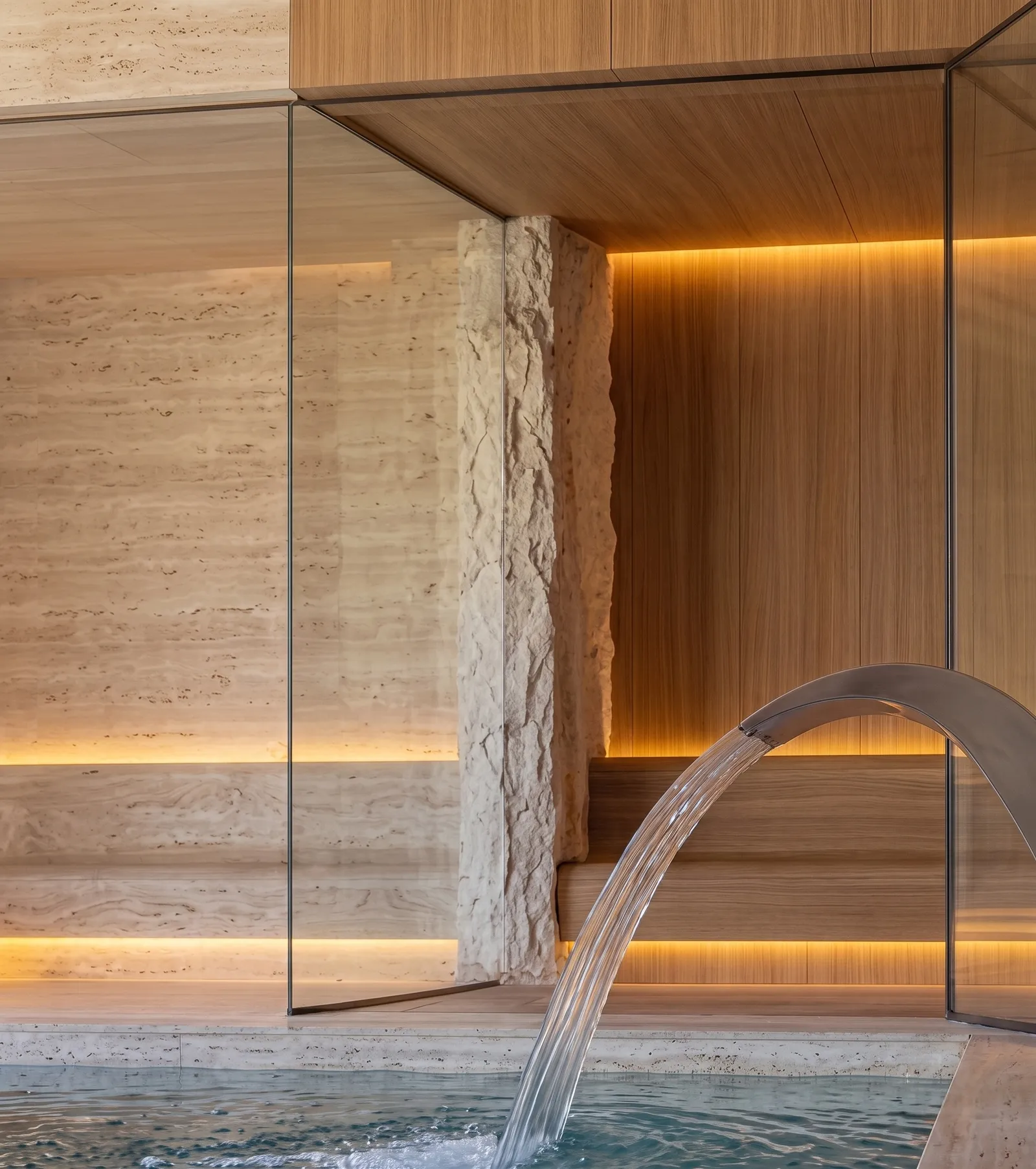 Sauna and spa of Casa Olive with travertine, wood and warm light